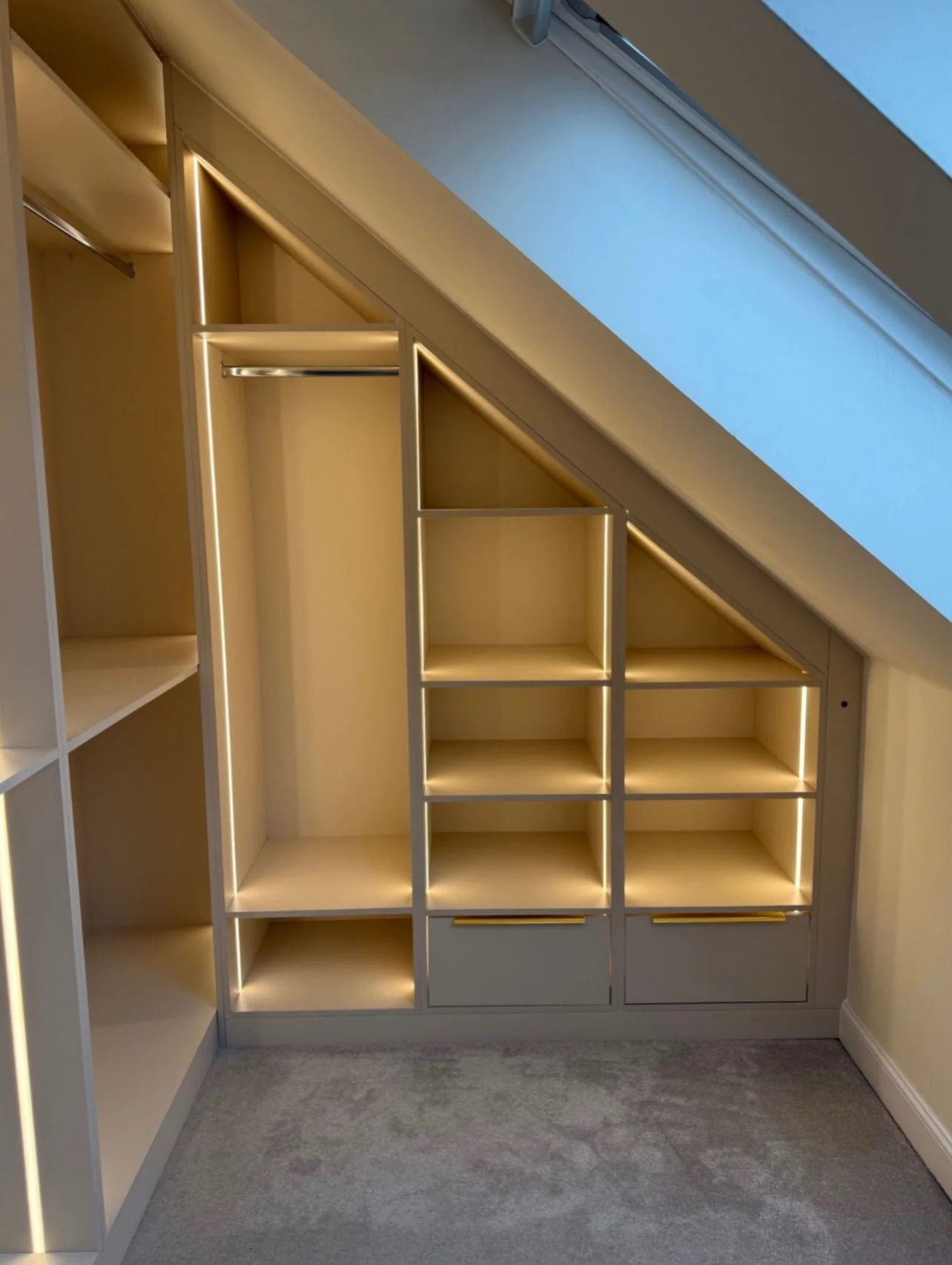 Eaves storage with built-in lighting in a loft room