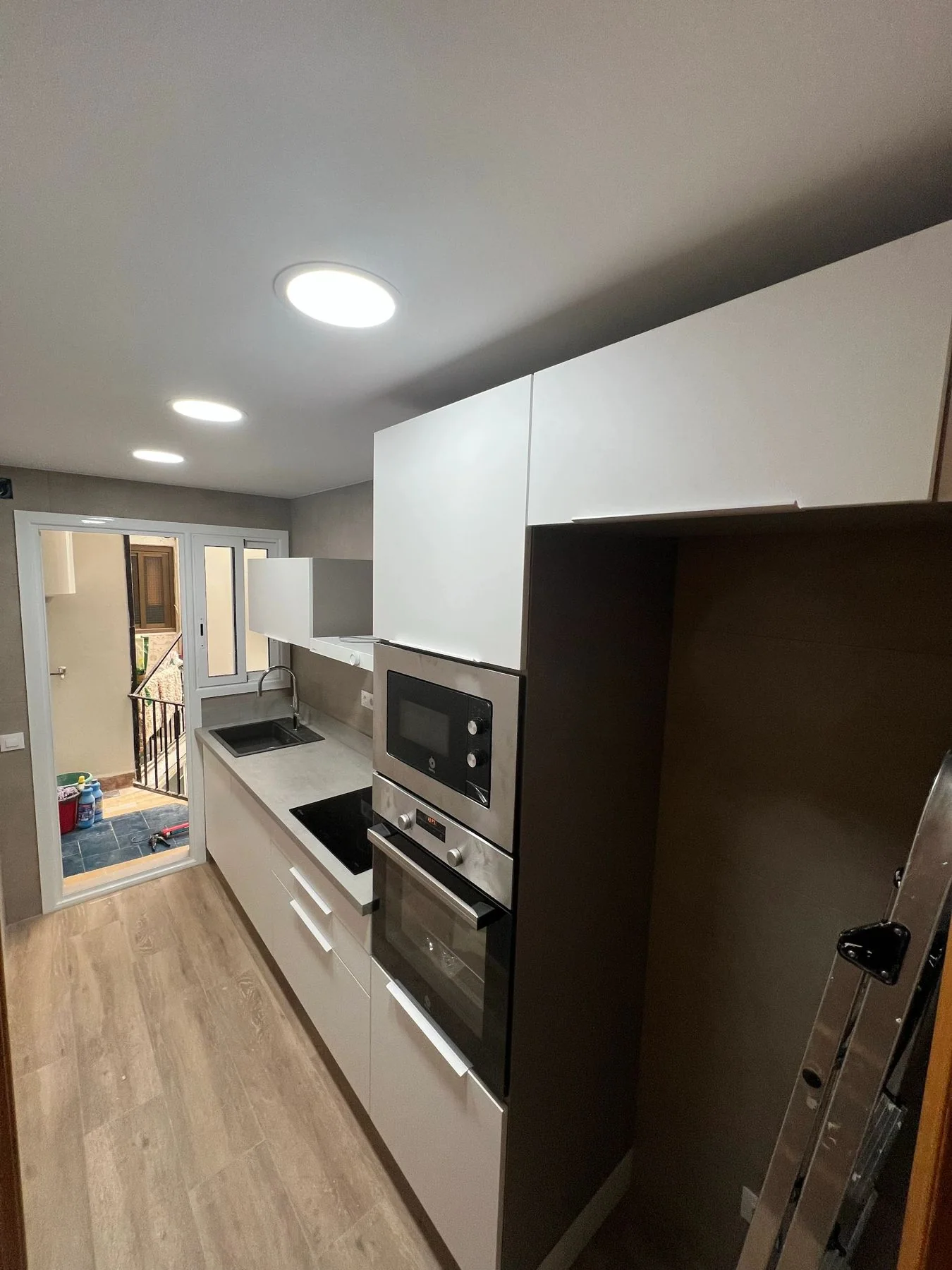Galley kitchen with integrated appliances