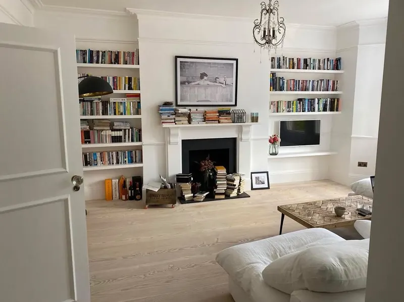 Built-in alcove shelving either side of a fireplace, made by AB Woodwork