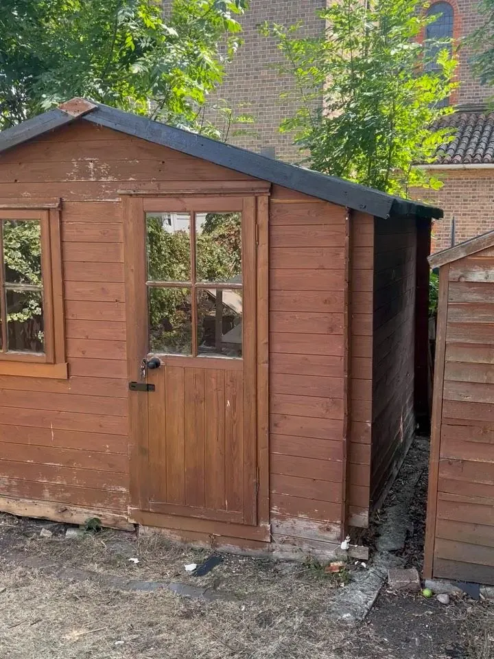 After: the same shed repaired with a new door side and roof