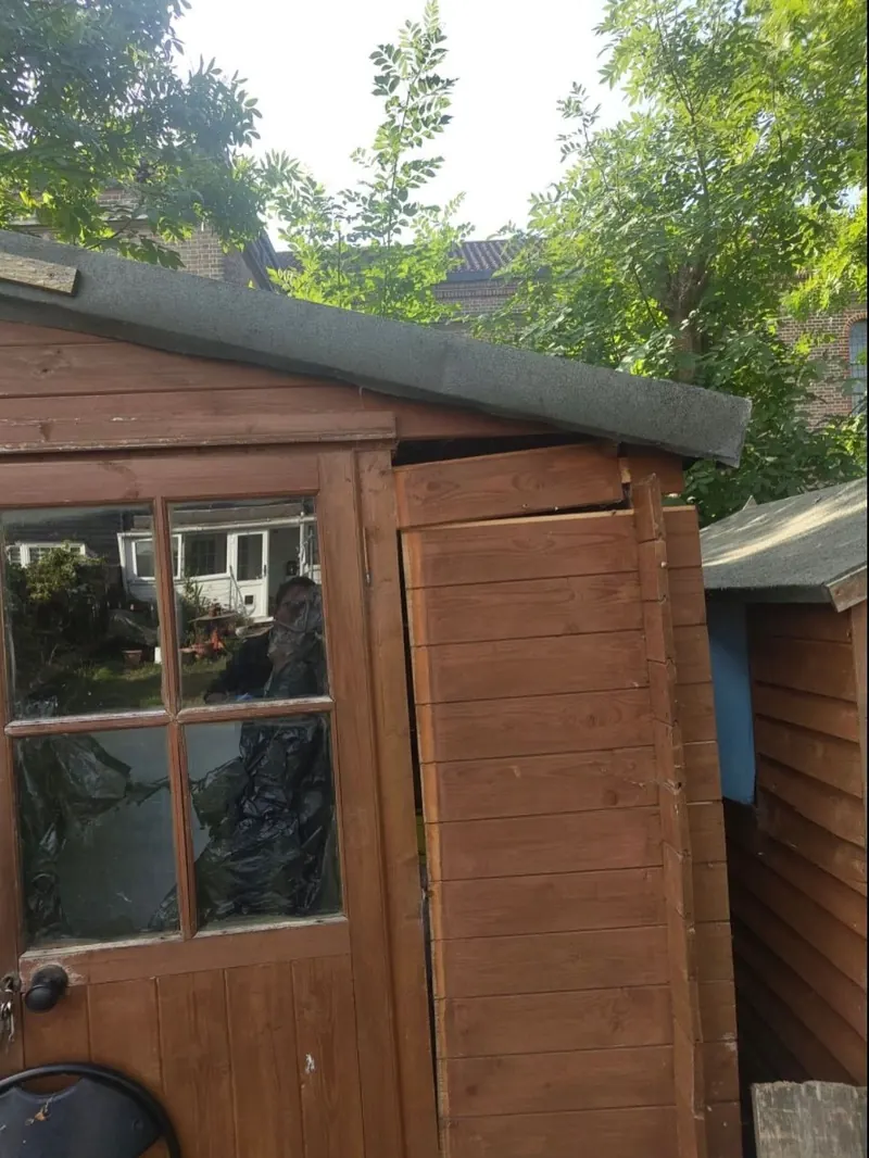 Before: a garden shed with rotten, broken boards